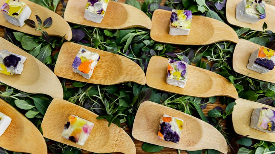 Small wooden trays of colorful cubes of food.