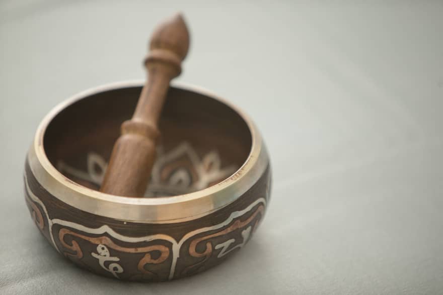 Small copper and wood bowl with decorative design, wood pestle