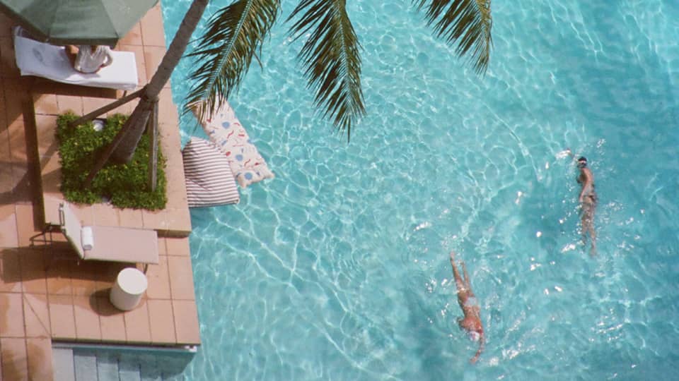 Aerial view of resort pool with palm trees