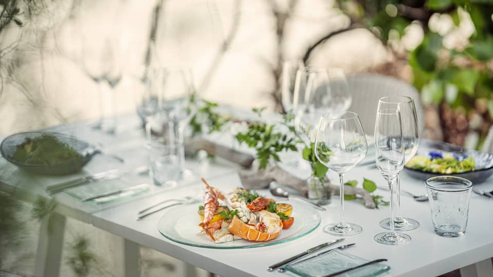 Dining table set, with seafood dish plated
