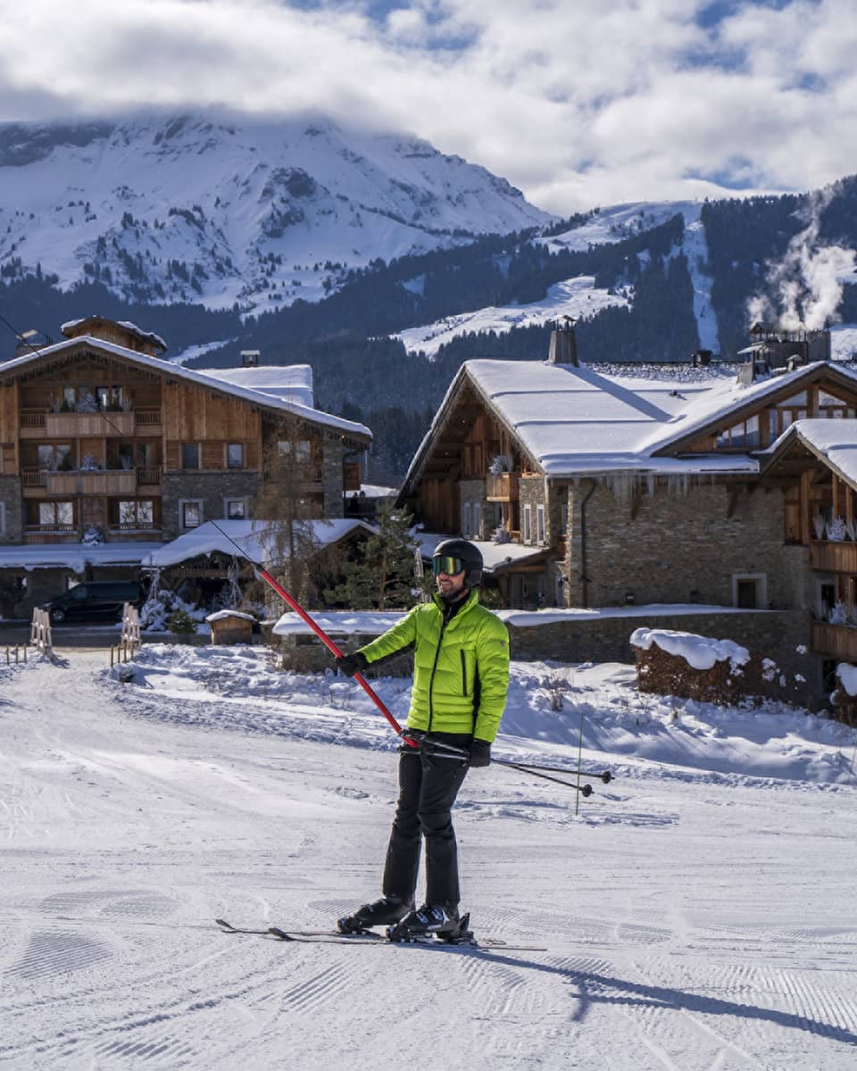 A person in a bright green ski jacket on snow.