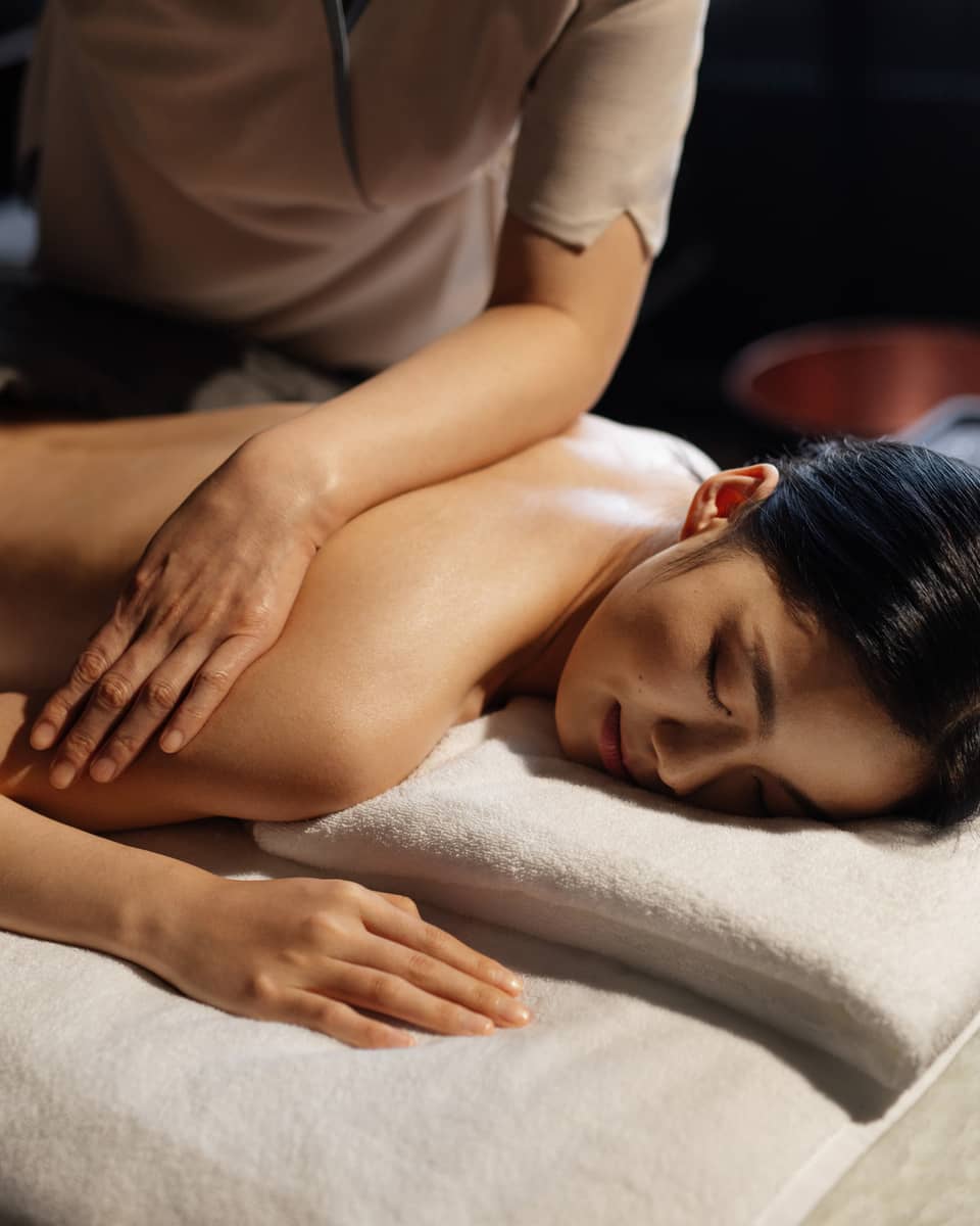Woman gets a massage at luxury hotel spa