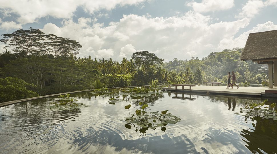 Guests explore the rooftop Lily Pond at Four Seasons Bali