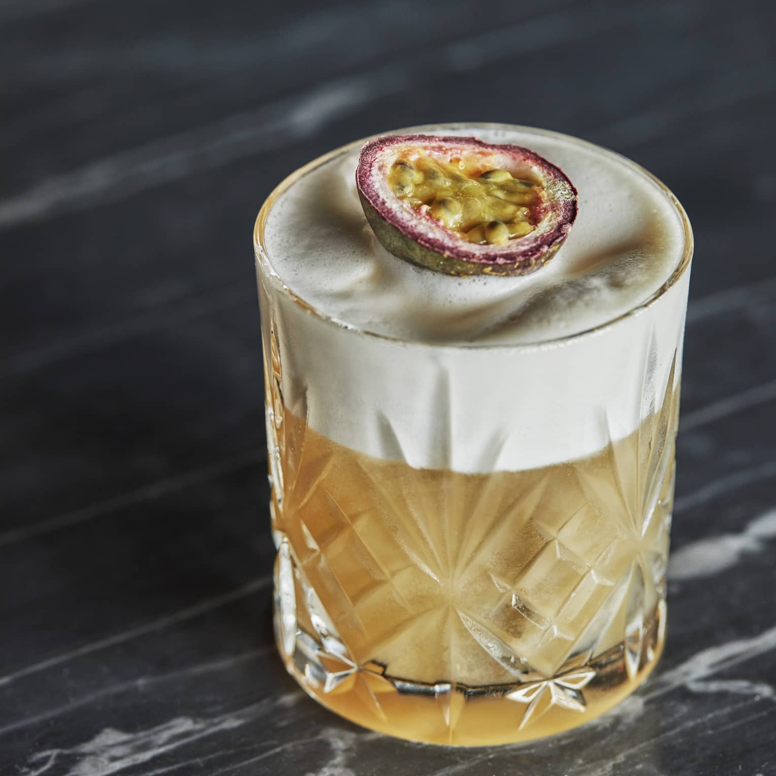 A cocktail in a glass with a fruit slice on top